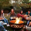 a group of people sitting around a firepit